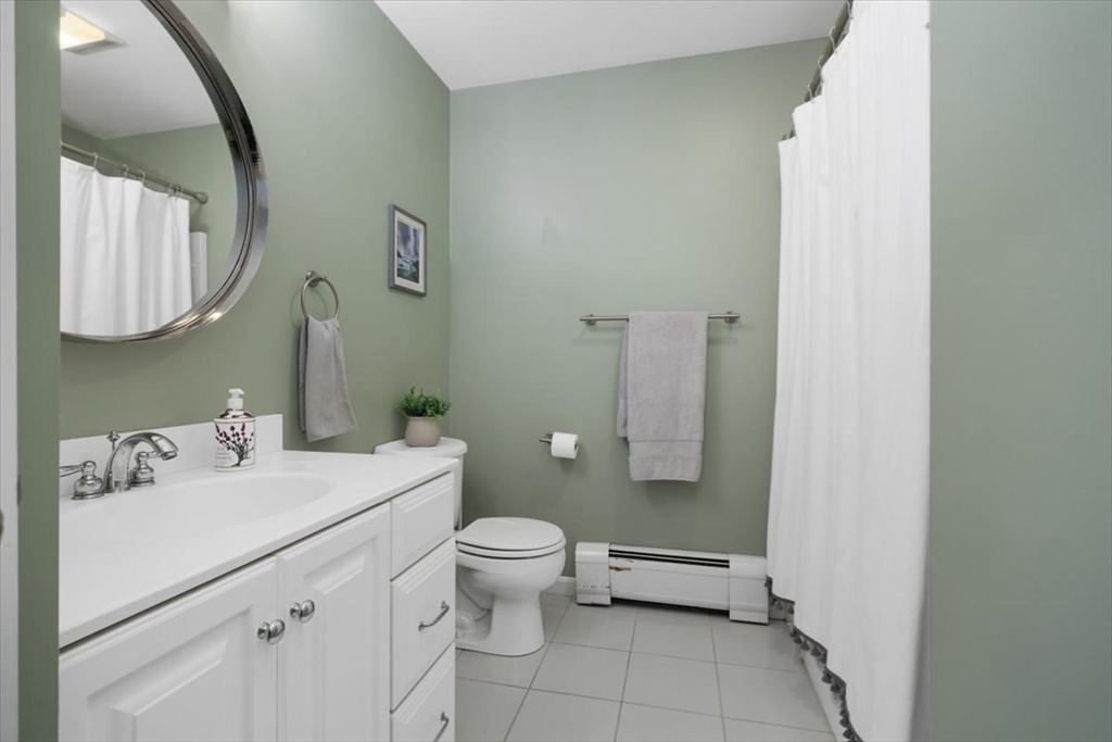 125 Maple Street Scituate, MA 02066 - Photo 24 of 42 a bathroom with a sink toilet and mirror