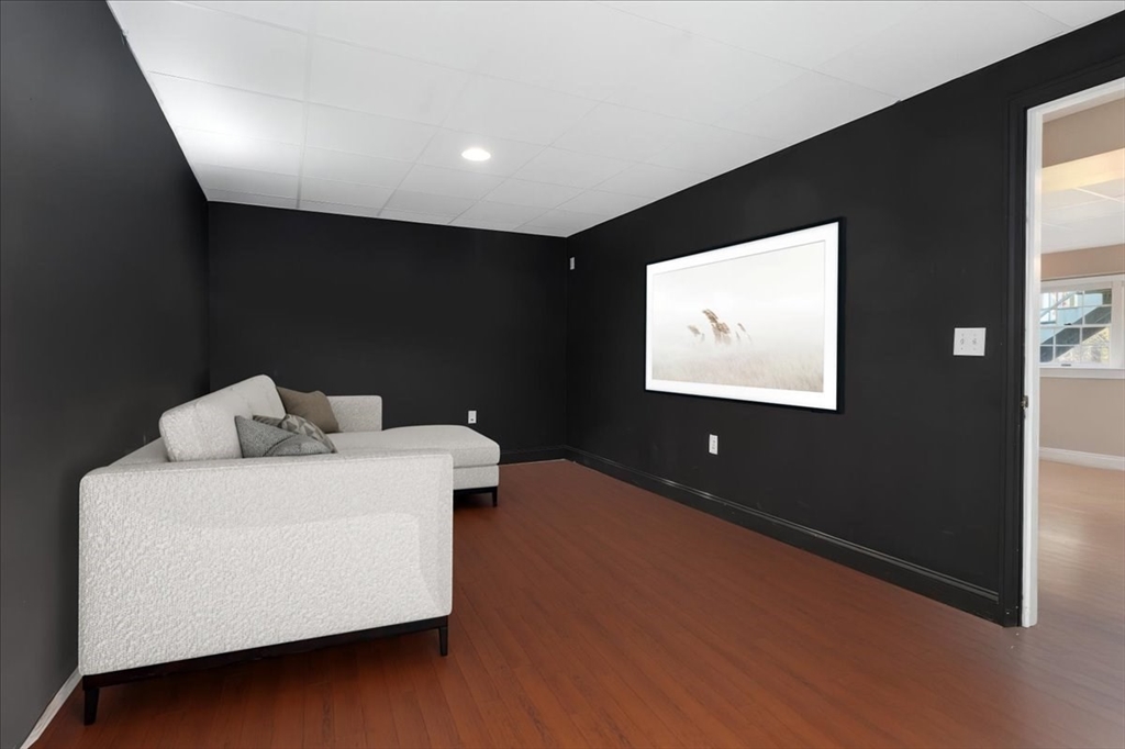 125 Maple Street Scituate, MA 02066 - Photo 31 of 42 a living room with furniture and a flat screen tv