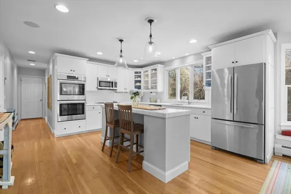 a kitchen with stainless steel appliances a refrigerator sink and microwave