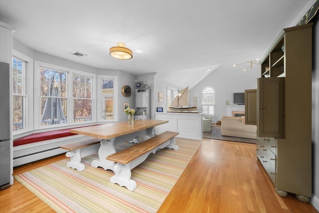 125 Maple Street Scituate, MA 02066 - Photo 7 of 42 a living room with a table chairs and a chandelier