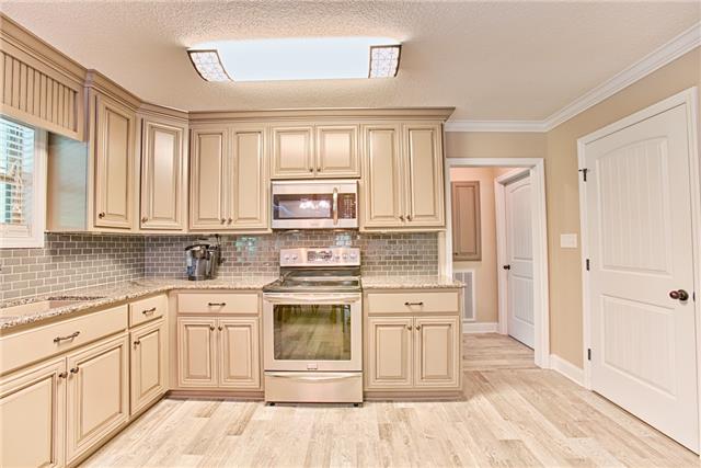 727 Lewter Hollow Road Ardmore, TN 38449 - Photo 8 of 20 a kitchen with white cabinets sink and appliances