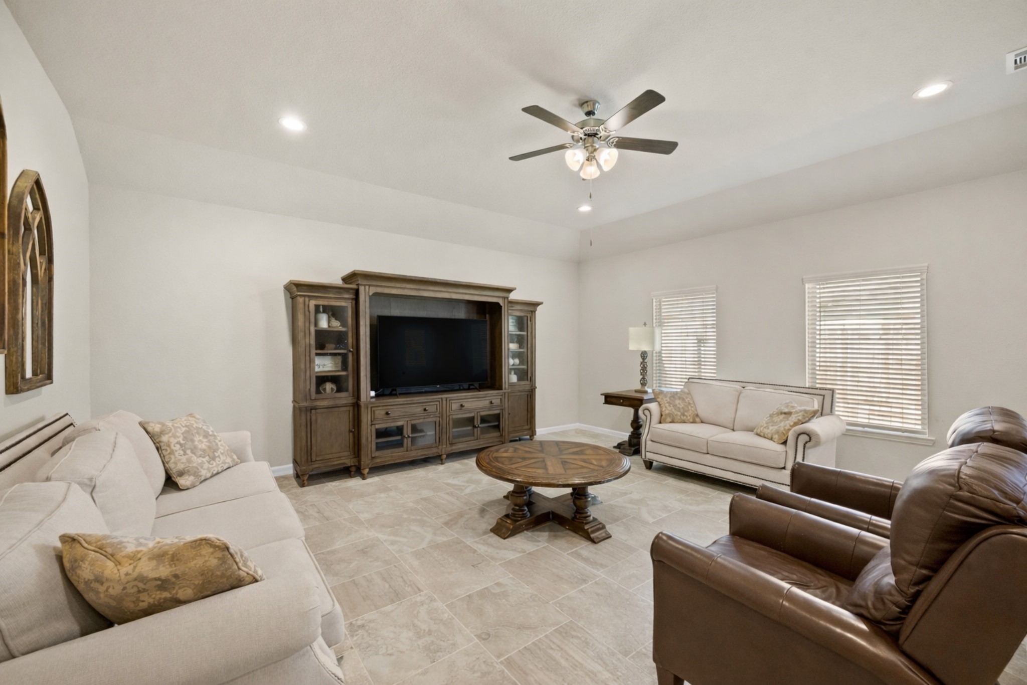 519 Yellow Bullhead Court Rosenberg, TX 77469 - Photo 6 of 24 Enter into this stunning great room where the atmosphere is elevated by soaring ceilings, creating a spacious and airy retreat. Ample room for multiple seating areas. Note the neutral paint and beautiful tile floors.
