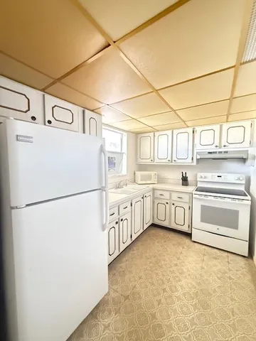 a kitchen with stainless steel appliances a refrigerator sink and cabinets