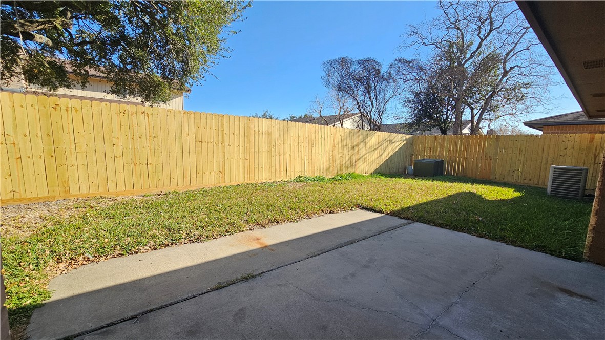 2438 Scotch Moss Drive Corpus Christi, TX 78414 - Photo 32 of 34 a view of backyard with large tree and wooden fence