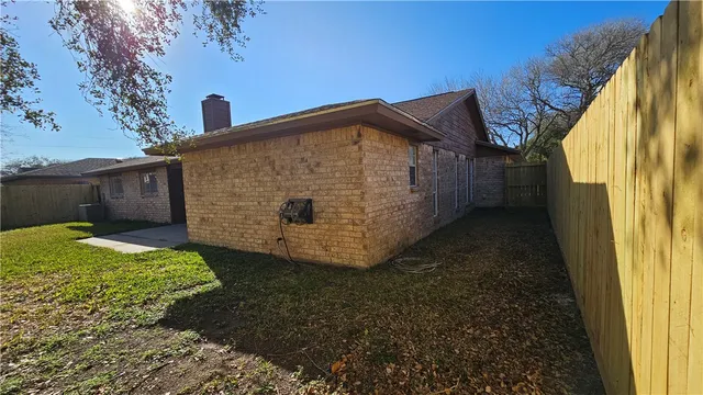 a view of backyard with a garden and deck