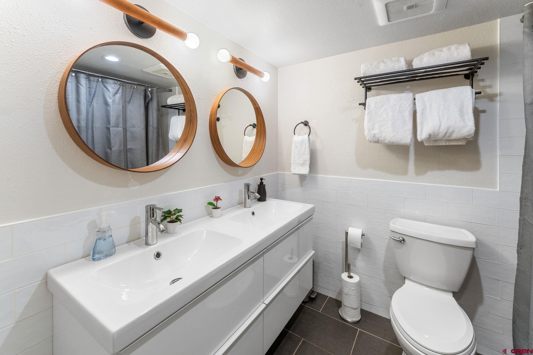 72 Hunter Hill Road, Unit I204 Crested Butte, CO 81225 - Photo 19 of 44 a bathroom with a toilet a sink and a mirror