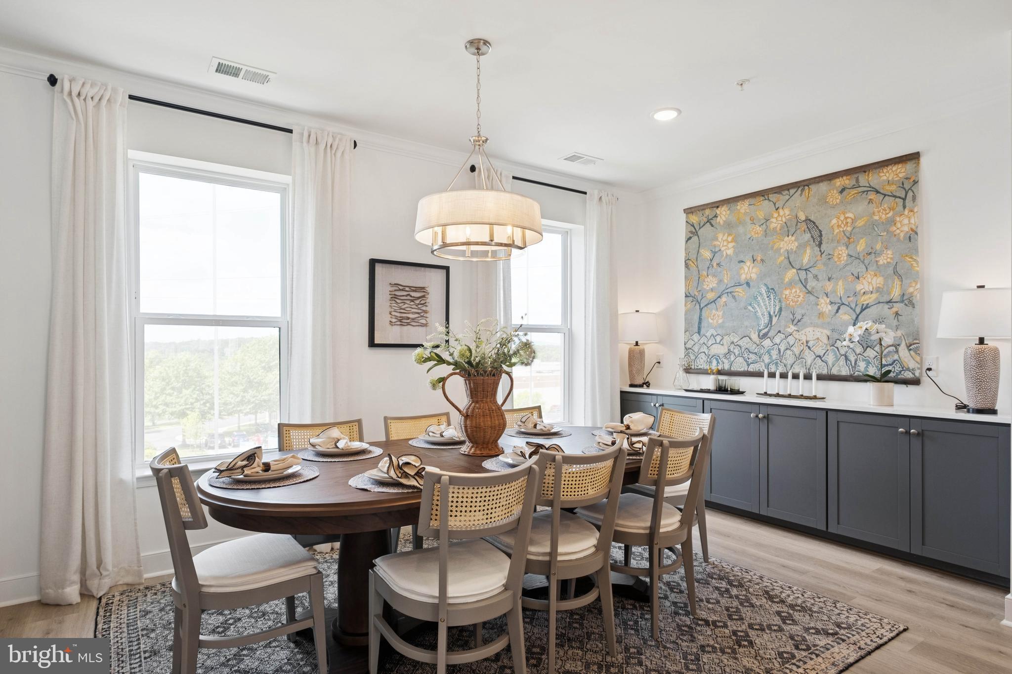 14962 Deco Circle Chantilly, VA 20151 - Photo 7 of 53 a dining room with wooden floor a chandelier a wooden table and chairs