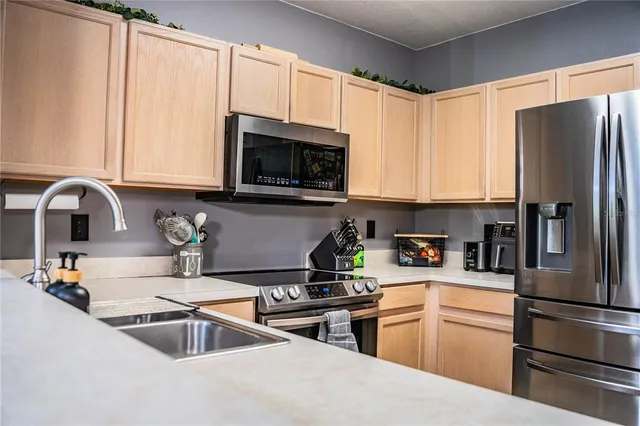 a view of a dining room and livingroom with furniture wooden floor a chandelier
