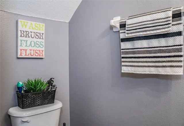 a bathroom with a sink a toilet a mirror and shower