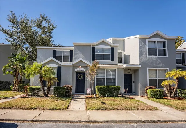 a front view of a house with garden and plants