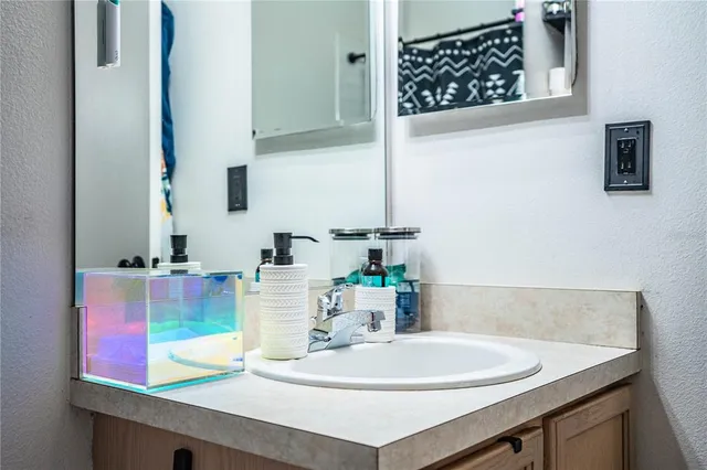 an aerial view of a city with lots of residential buildings ocean and mountain view in back