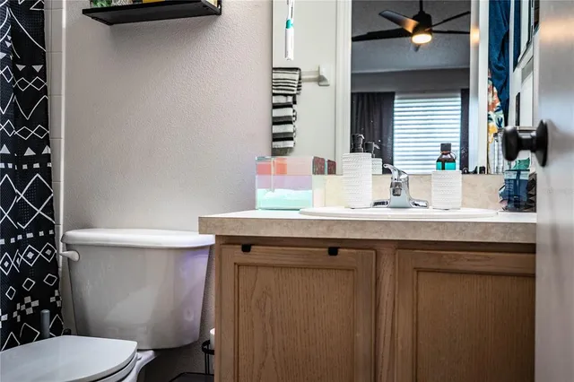 a view of a white house with a swimming pool lawn chairs and a barbeque