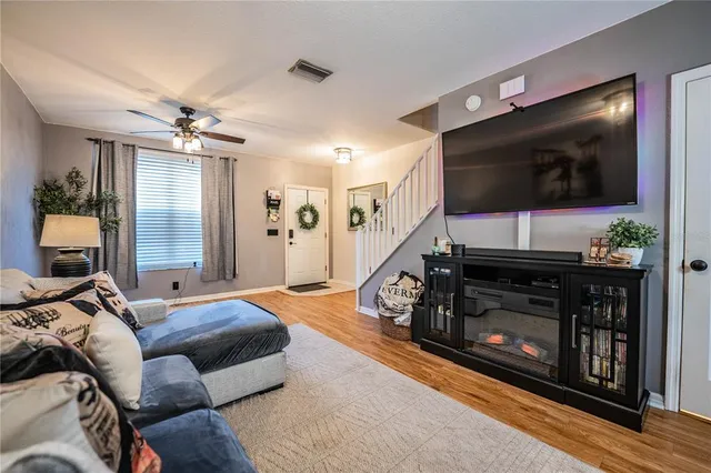 a living room with furniture a flat screen tv and a fireplace