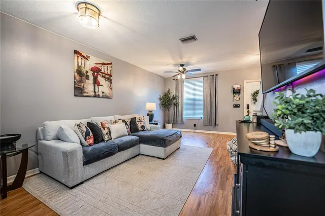 a living room with furniture and a chandelier