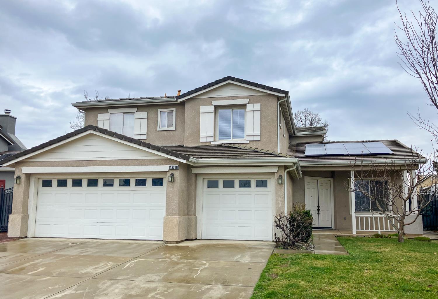 13310 Parkhaven Street Lathrop, CA 95330 - Photo 1 of 27 a front view of a house with a yard and garage