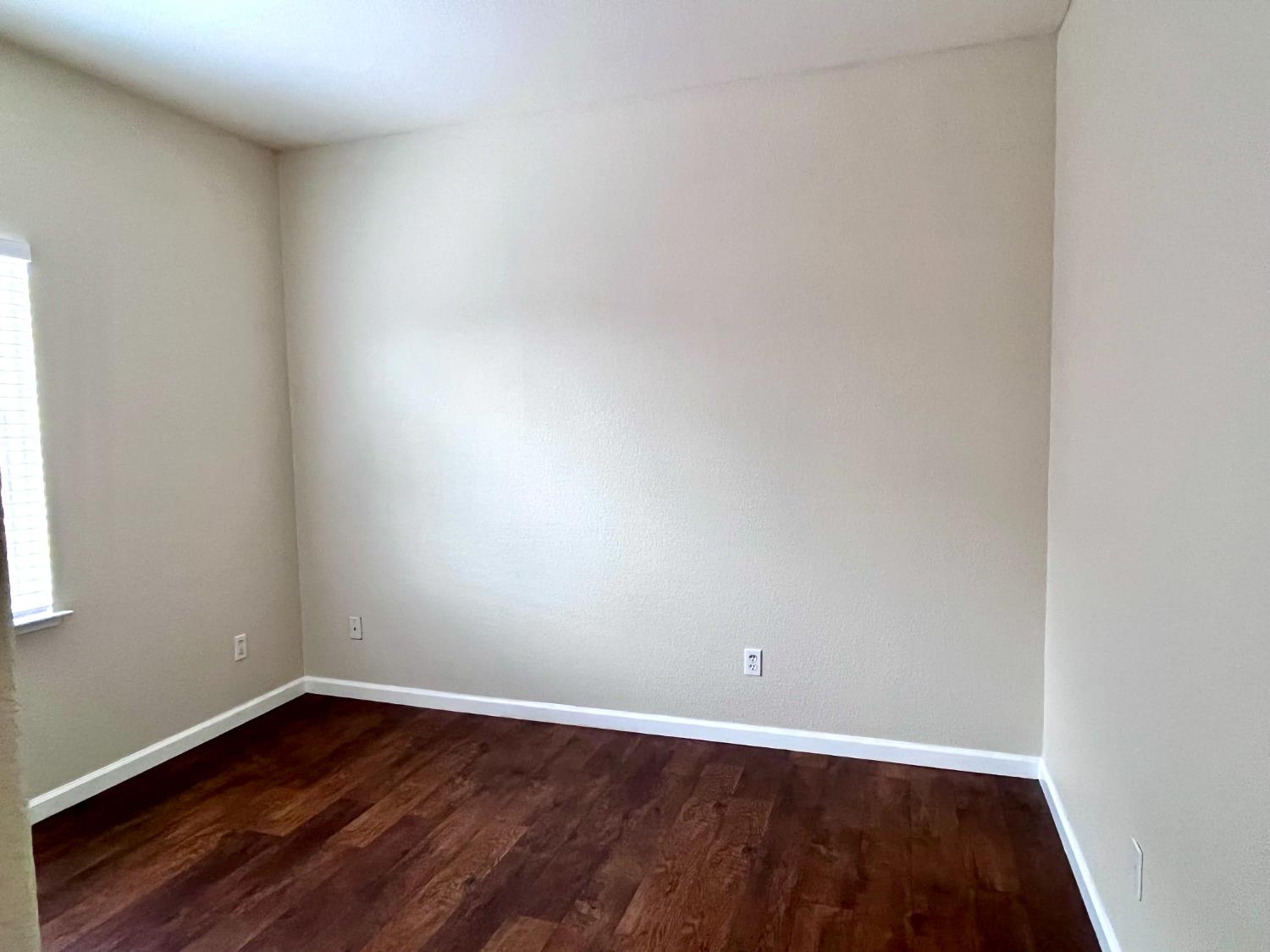 13310 Parkhaven Street Lathrop, CA 95330 - Photo 12 of 27 a view of an empty room with wooden floor