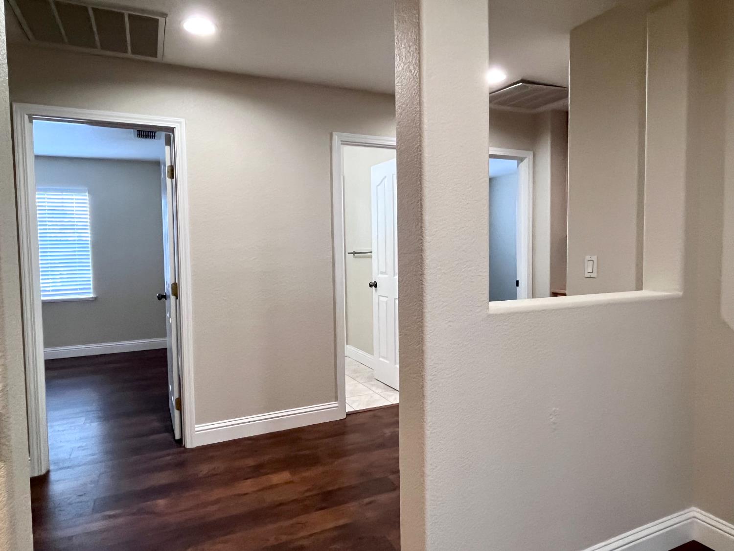13310 Parkhaven Street Lathrop, CA 95330 - Photo 13 of 27 a view of an empty room with wooden floor and a bathroom