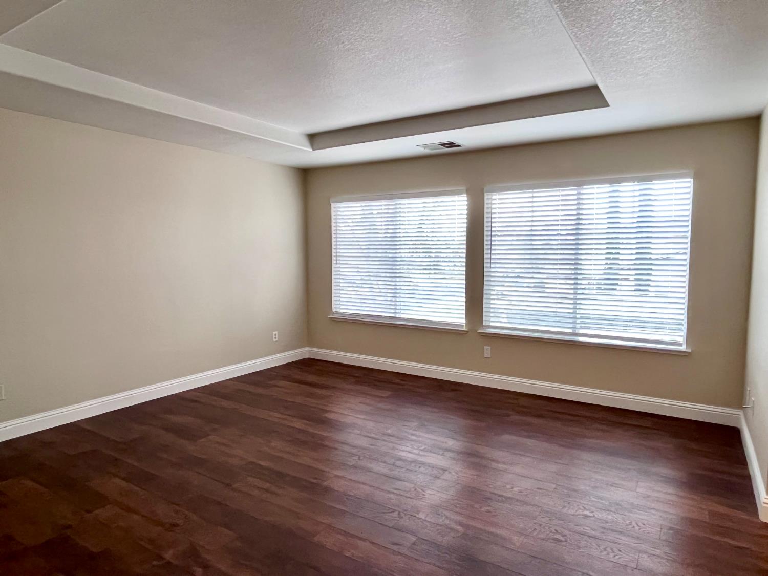 13310 Parkhaven Street Lathrop, CA 95330 - Photo 15 of 27 a view of an empty room with wooden floor and a window