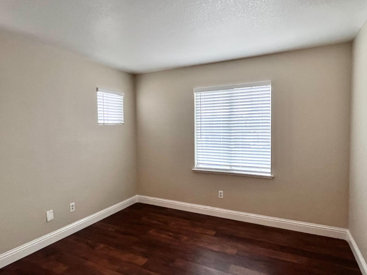 13310 Parkhaven Street Lathrop, CA 95330 - Photo 19 of 27 an empty room with wooden floor and a window