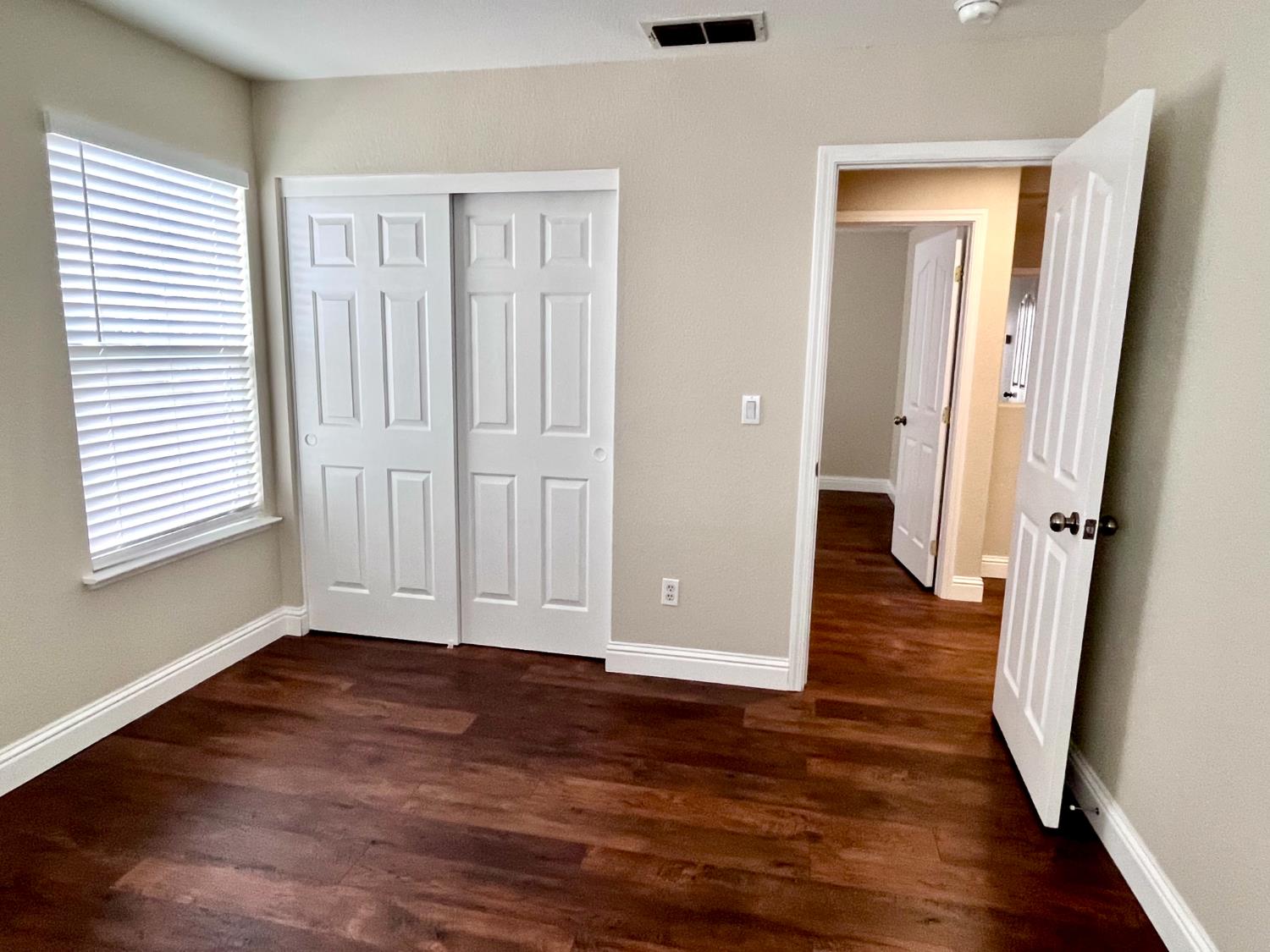 13310 Parkhaven Street Lathrop, CA 95330 - Photo 21 of 27 an empty room with wooden floor and windows