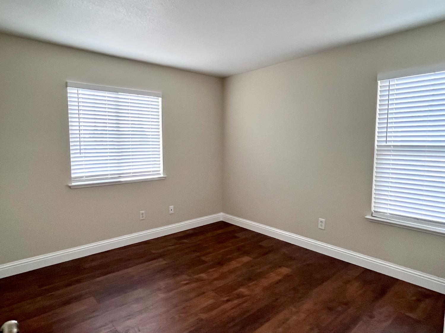 13310 Parkhaven Street Lathrop, CA 95330 - Photo 22 of 27 an empty room with wooden floor and a window