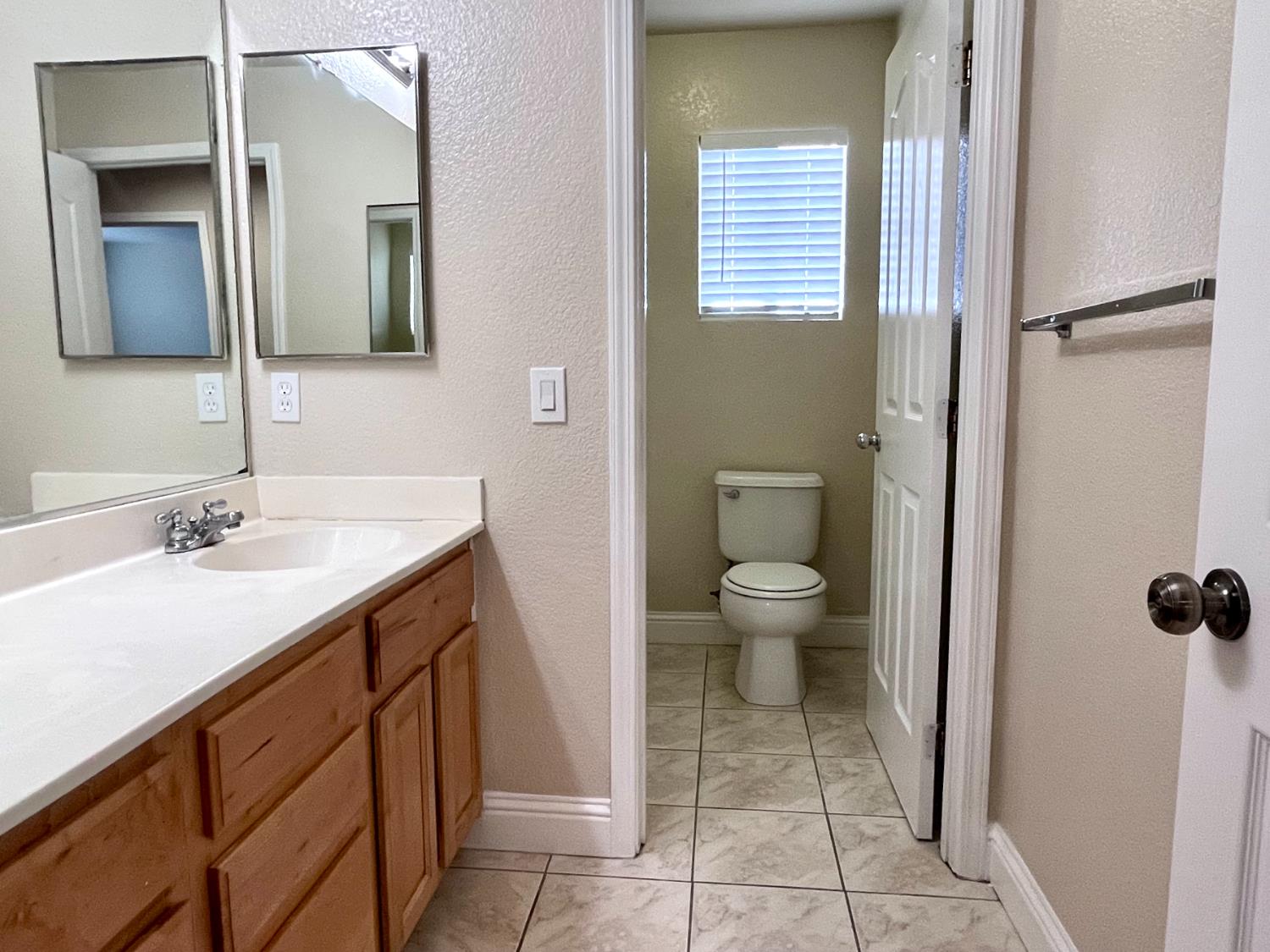 13310 Parkhaven Street Lathrop, CA 95330 - Photo 23 of 27 a bathroom with a sink a toilet and a mirror