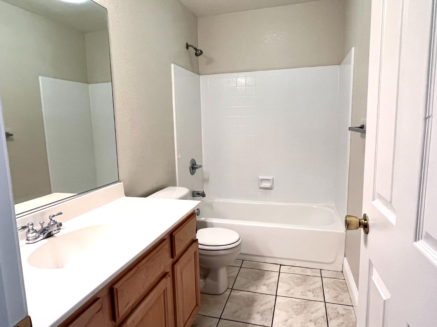 13310 Parkhaven Street Lathrop, CA 95330 - Photo 26 of 27 a bathroom with a sink a toilet and a bathtub