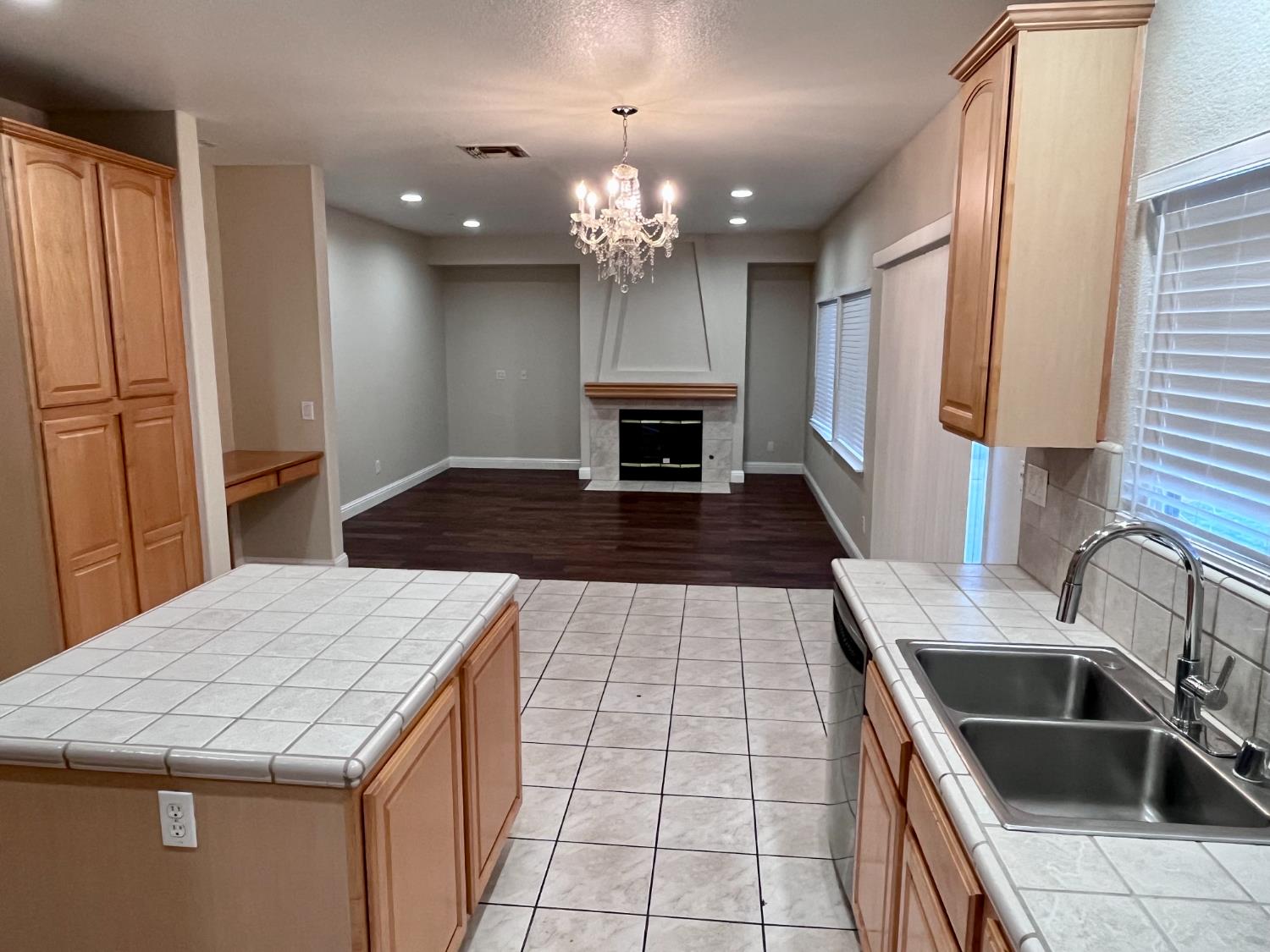 13310 Parkhaven Street Lathrop, CA 95330 - Photo 6 of 27 a kitchen with kitchen island granite countertop a sink stove and refrigerator