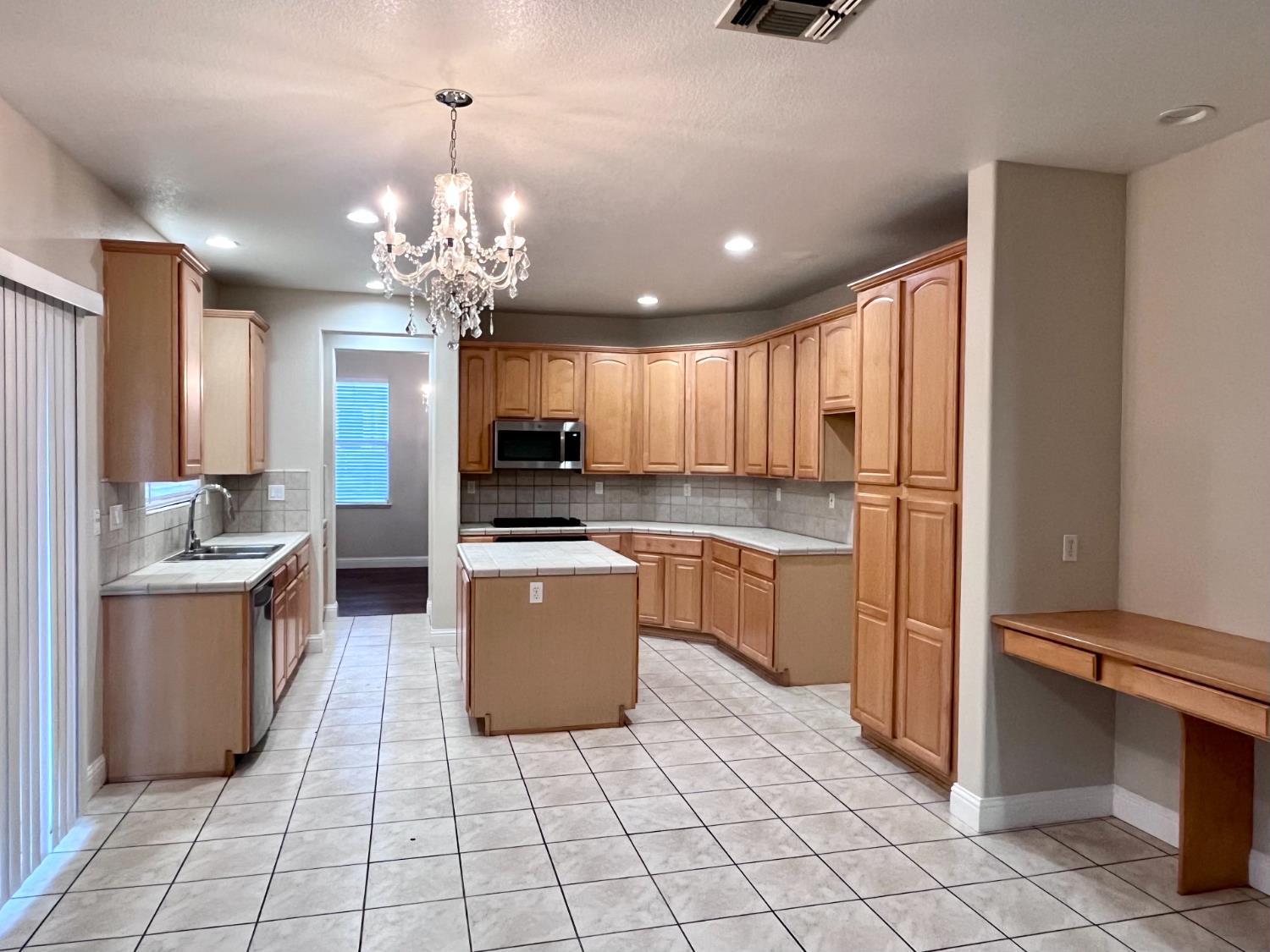 13310 Parkhaven Street Lathrop, CA 95330 - Photo 8 of 27 a kitchen with stainless steel appliances a refrigerator sink and cabinets