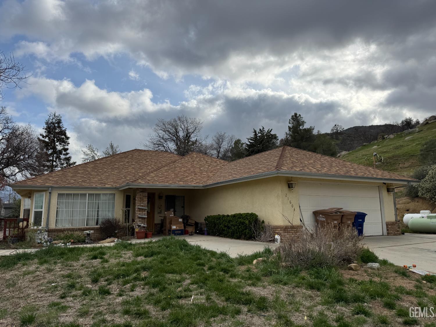 Undisclosed Address Tehachapi, CA 93561 - Photo 1 of 11 a front view of a house with garden