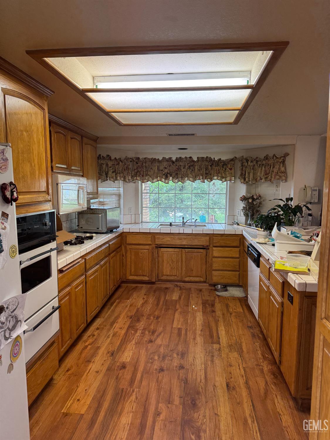 Undisclosed Address Tehachapi, CA 93561 - Photo 5 of 11 a kitchen with a sink wooden floor and stainless steel appliances