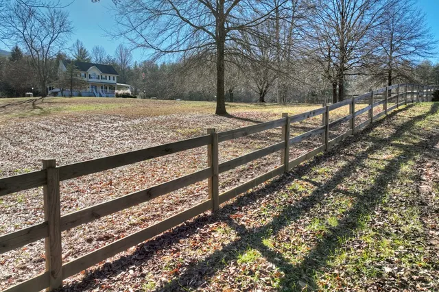 a large white kitchen with stainless steel appliances and cabinets