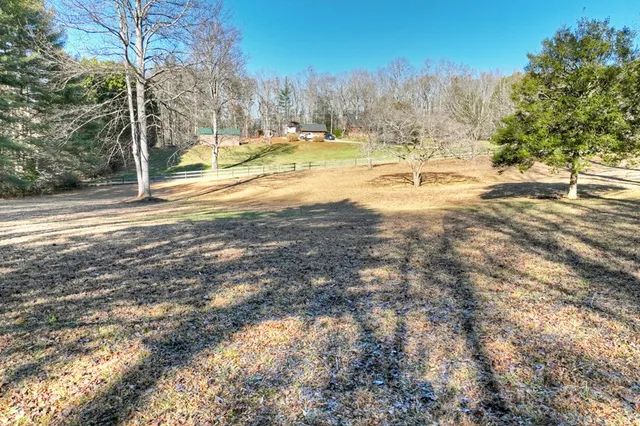 a large white kitchen with stainless steel appliances granite countertop a stove and a sink
