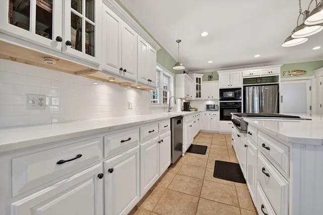 a living room with a bed furniture and a book shelf