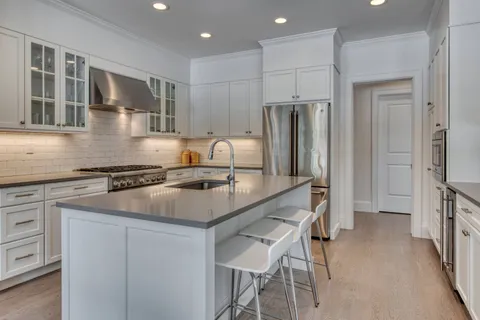 a kitchen with kitchen island a sink stove and refrigerator