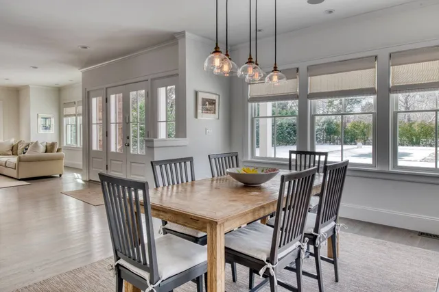 a view of a dining room with furniture large windows and wooden floor