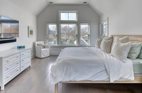 a spacious bedroom with a bed and window