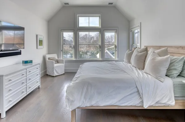 a spacious bedroom with a bed and window
