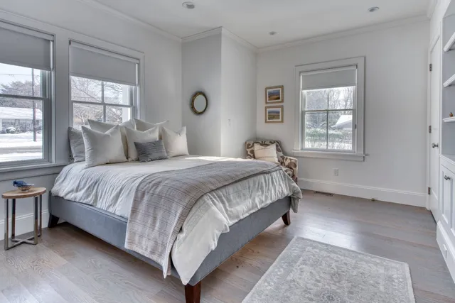 a bedroom with a bed lamp and window