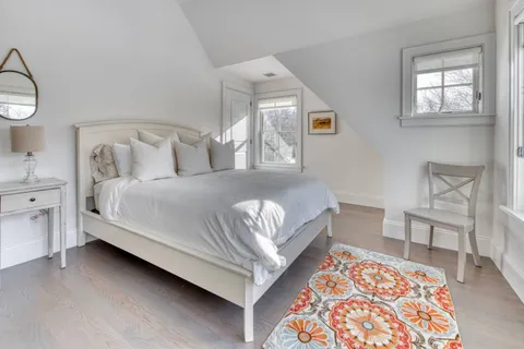 a bedroom with a bed and a chair