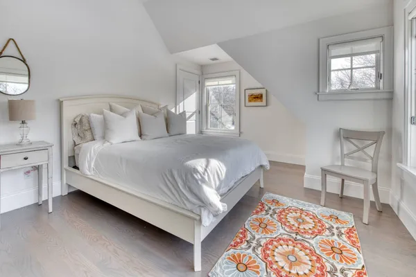 a bedroom with a bed and a chair