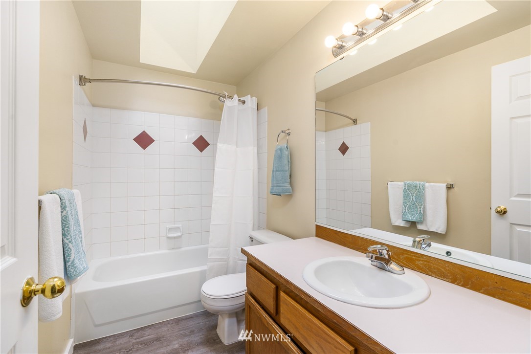 19104 113th Way Southeast Renton, WA 98055 - Photo 13 of 30 a bathroom with a granite countertop sink toilet tub and shower