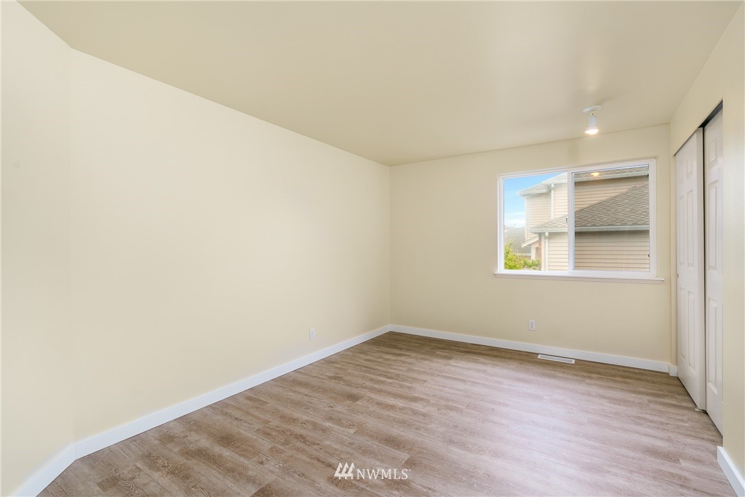 19104 113th Way Southeast Renton, WA 98055 - Photo 14 of 30 an empty room with wooden floor and windows