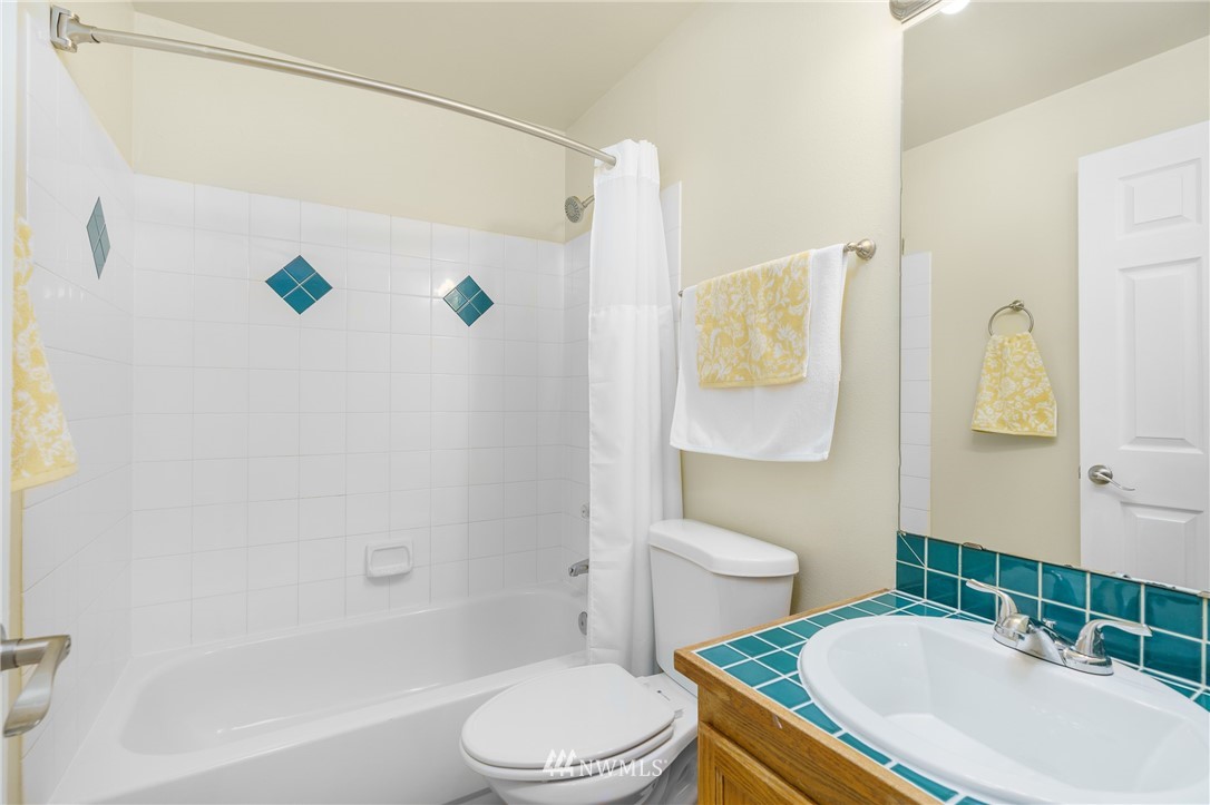 19104 113th Way Southeast Renton, WA 98055 - Photo 15 of 30 a white toilet sitting next to a bathroom sink and tub