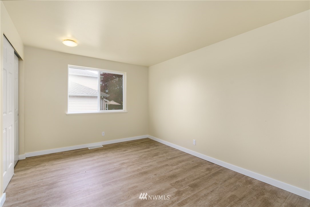 19104 113th Way Southeast Renton, WA 98055 - Photo 16 of 30 an empty room with wooden floor and windows