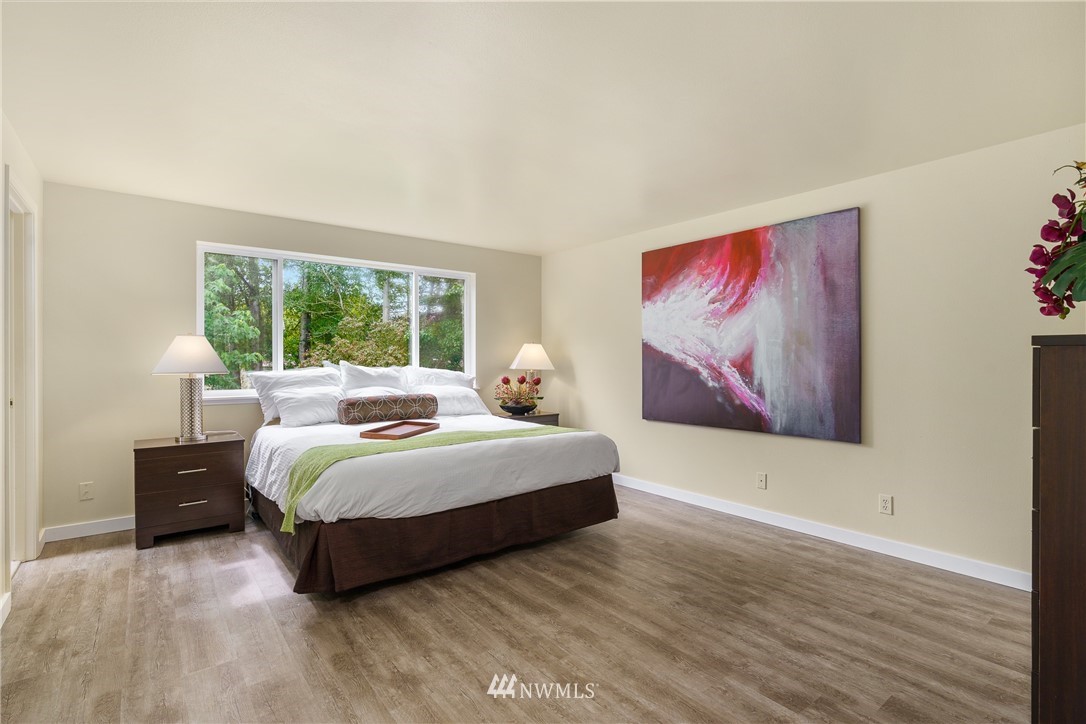 19104 113th Way Southeast Renton, WA 98055 - Photo 18 of 30 a bedroom with a bed and a painting on the wall