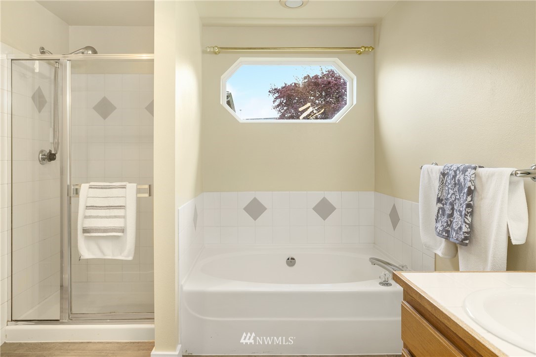 19104 113th Way Southeast Renton, WA 98055 - Photo 19 of 30 a bathroom with a bathtub and a shower