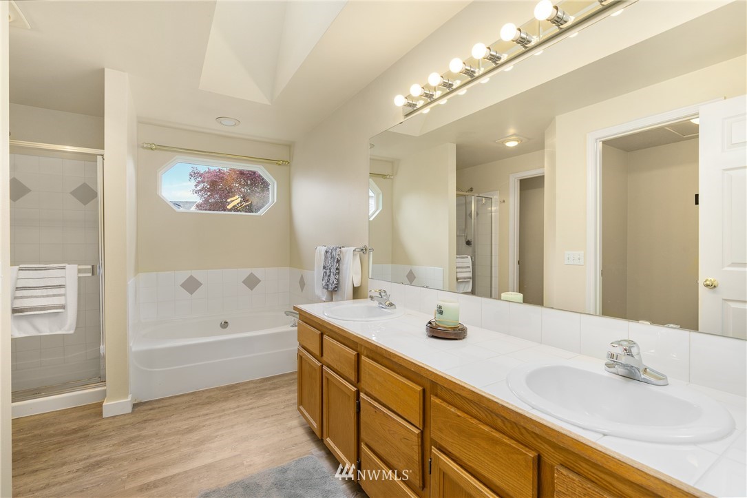 19104 113th Way Southeast Renton, WA 98055 - Photo 20 of 30 a spacious bathroom with a tub a sink and mirror