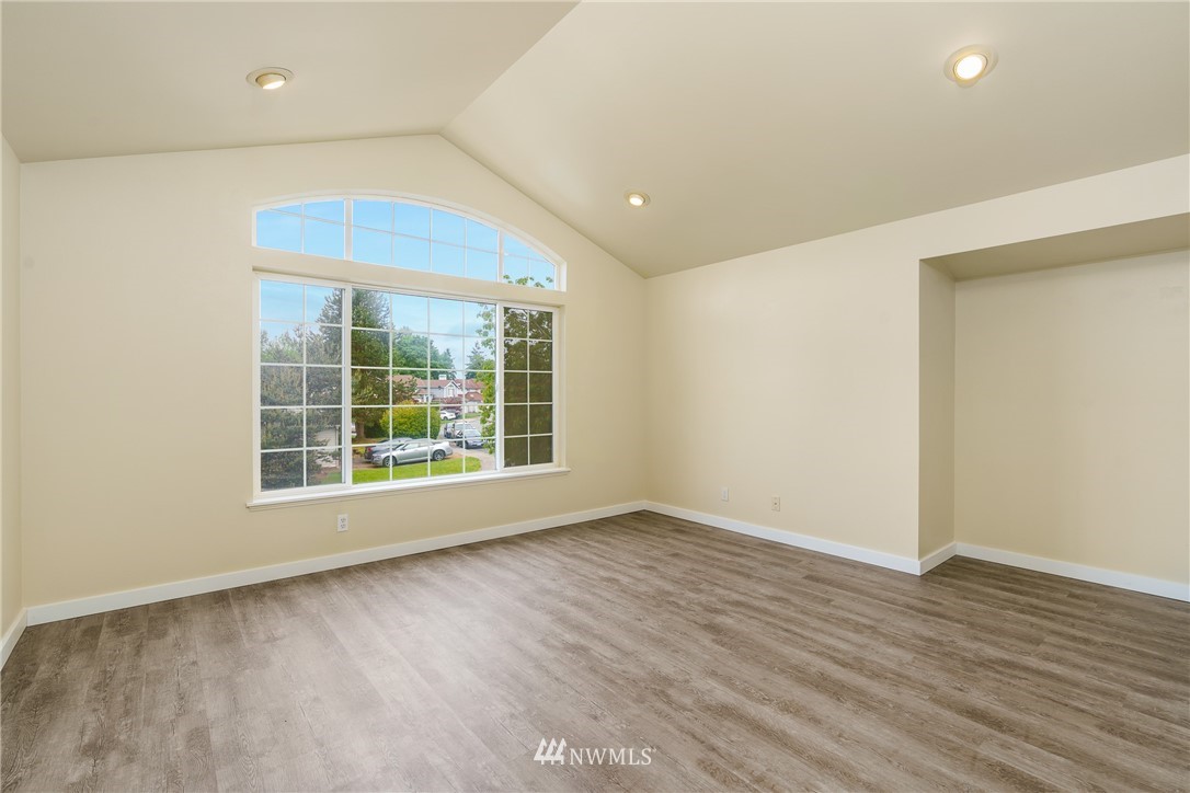 19104 113th Way Southeast Renton, WA 98055 - Photo 21 of 30 a view of an empty room with wooden floor and a window