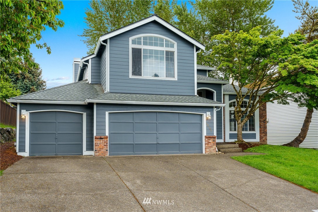 19104 113th Way Southeast Renton, WA 98055 - Photo 29 of 30 a front view of a house with a yard and garage